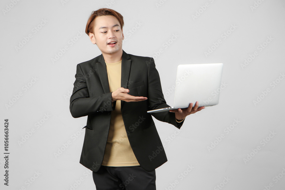 portrait of happy asian businessman holding laptop computer wearing suit on isolated background portrait of happy asian businessman holding laptop computer wearing suit on isolated background