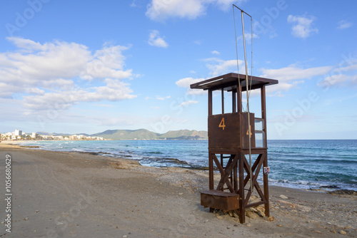 A rustic lifeguard tower stands on a beach mallorca balearic islands