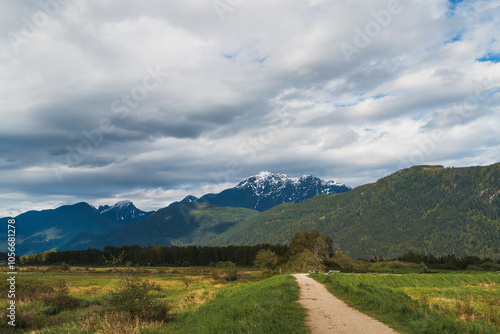 Pathway with mountain background and dramatic clouds photo