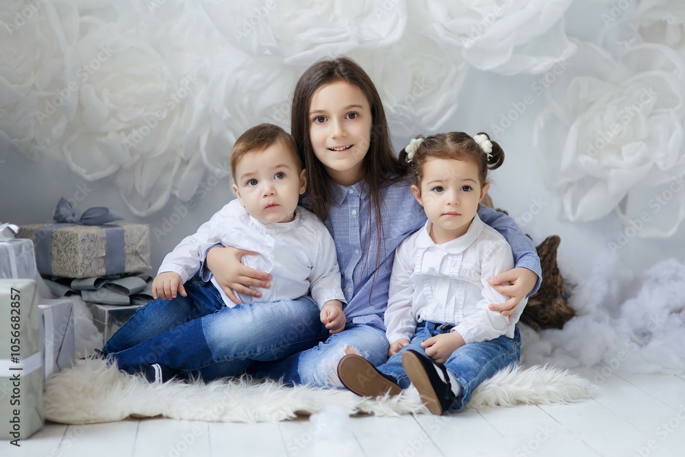 Fototapeta premium Beautiful children sitting in a room decorated for the new year