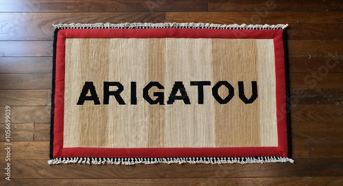 arigatou text on mat rug in wooden floor background photo