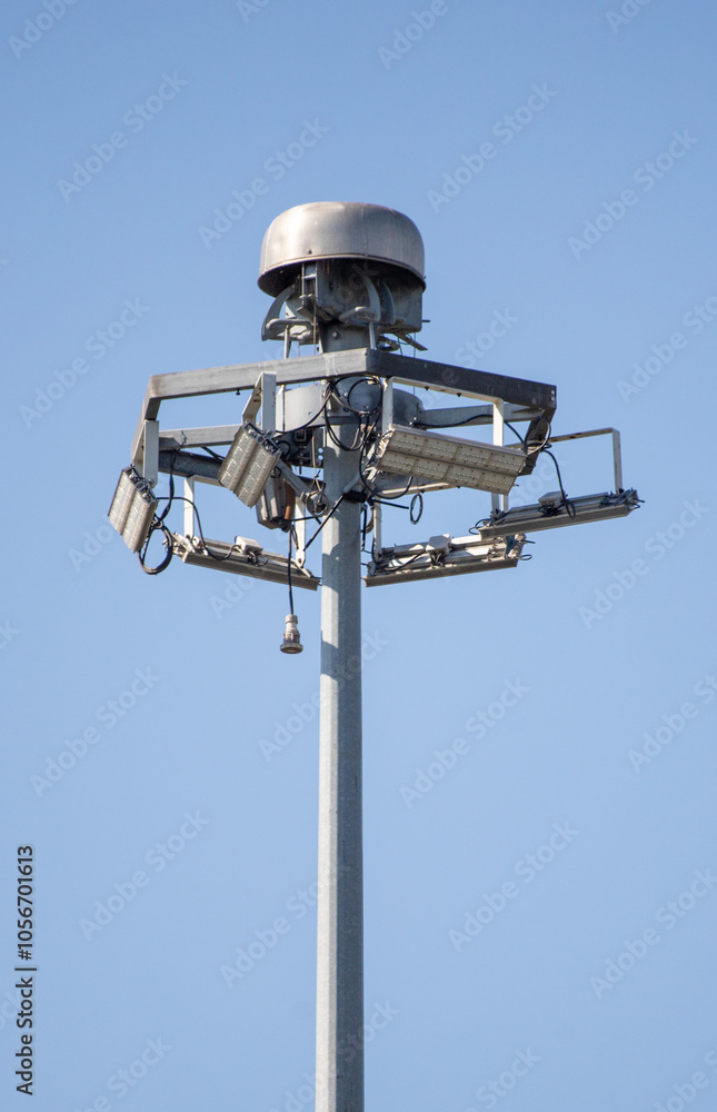 A tall pole with a light fixture on top A tall pole with a light fixture on top