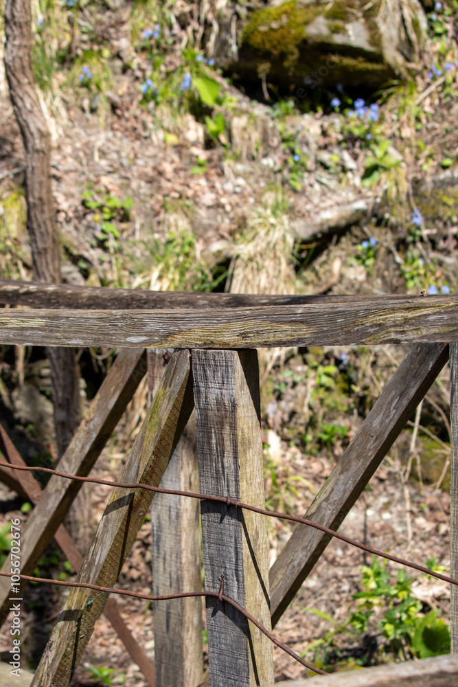 A wooden post with a metal fence around it A wooden post with a metal fence around it