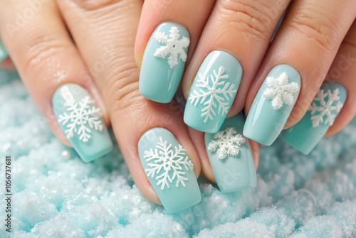 Blue winter nails with snowflake designs on textured background

 photo