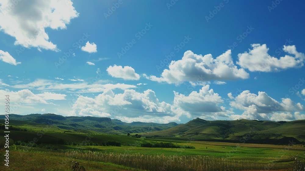 Obraz premium The allure of a landscape filled with the beauty of blue sky, fluffy white clouds, majestic high mountains, and vibrant green plants. Generative AI