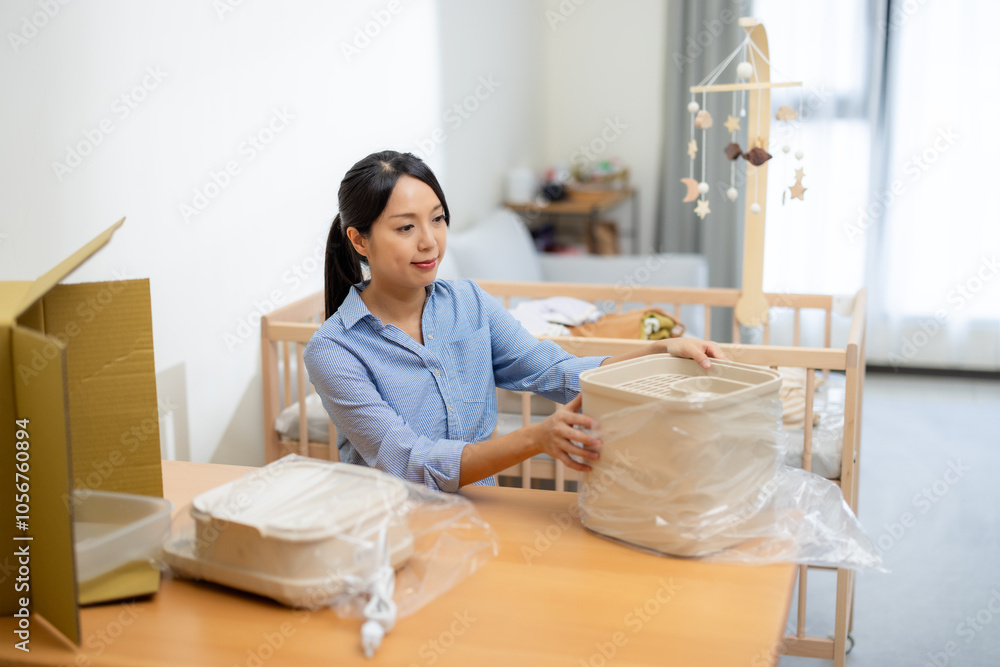 Pregnant woman prepare newborn baby stuff Pregnant woman prepare newborn baby stuff