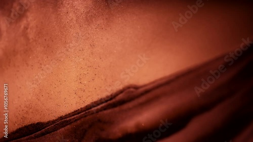 Abstract macro shot of sandy dust particles floating above the sand pile. 