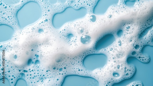 White soap foam with bubbles on a blue background Detergent bubbles and suds create a texture ideal for beauty cleansing and laundry applications photo