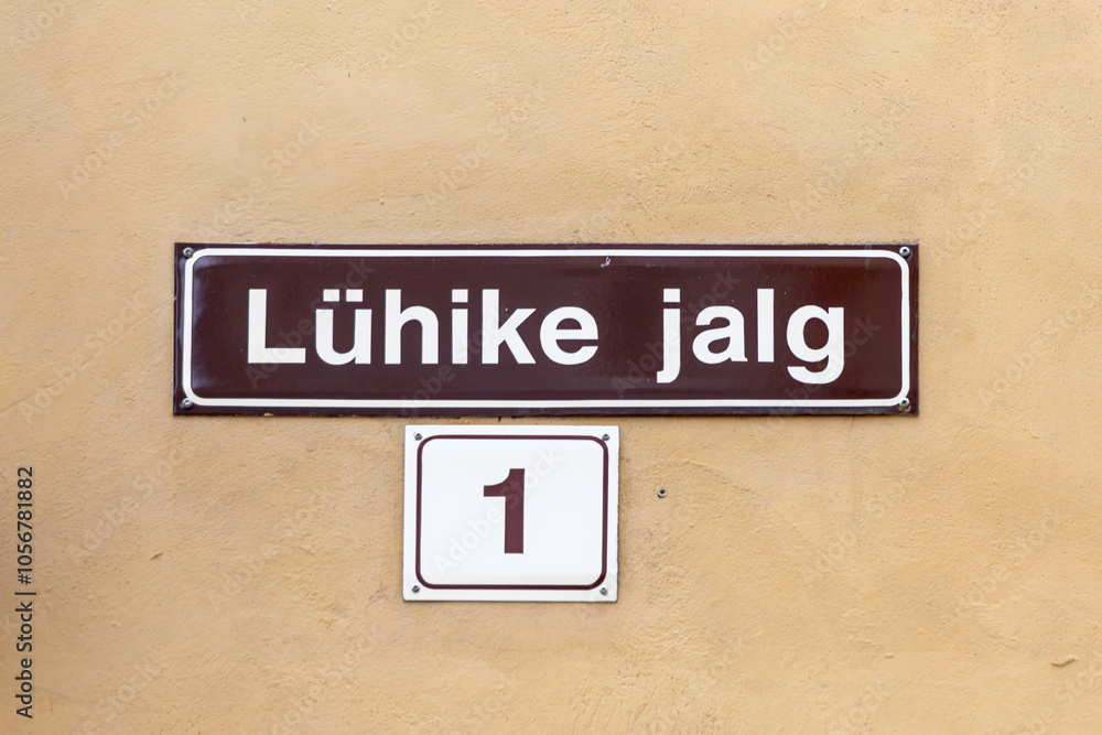 old enamel streetname Lühike jalg,1 in Tallinn, Estonia at an old wall in the old town old enamel streetname Lühike jalg,1 in Tallinn, Estonia at an old wall in the old town