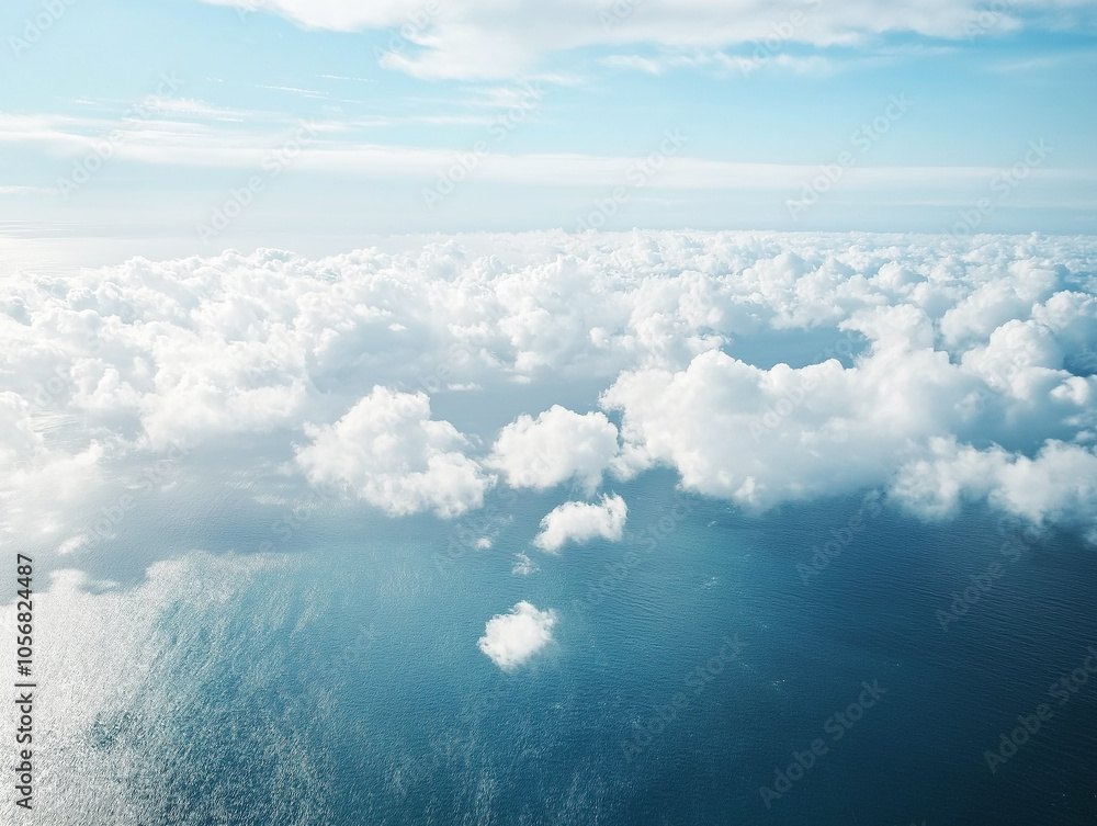 Naklejka premium Stunning aerial view of fluffy white clouds against a blue sky, creating a sense of tranquility and openness. Ideal for backgrounds or themes involving freedom and flight.