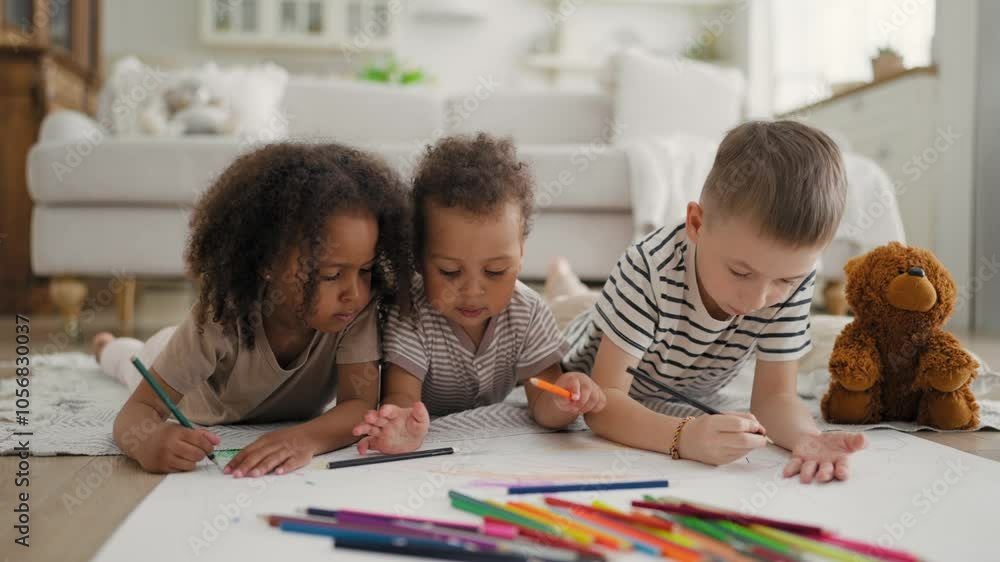 Little friends drawing by crayons, Black and Caucasian children playing together . Happy and carefree childhood, cute toddler and kids spending time and having fun in weekend, develop of creativity Little friends drawing by crayons, Black and Caucasian children playing together . Happy and carefree childhood, cute toddler and kids spending time and having fun in weekend, develop of creativity