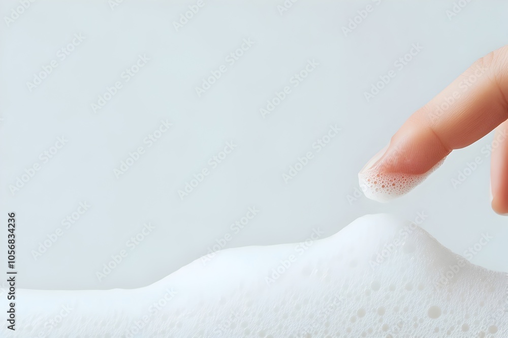 Finger Pushing Down on Fresh White Shampoo Foam with Detailed Skin Texture in Elegant Macro Finger Pushing Down on Fresh White Shampoo Foam with Detailed Skin Texture in Elegant Macro