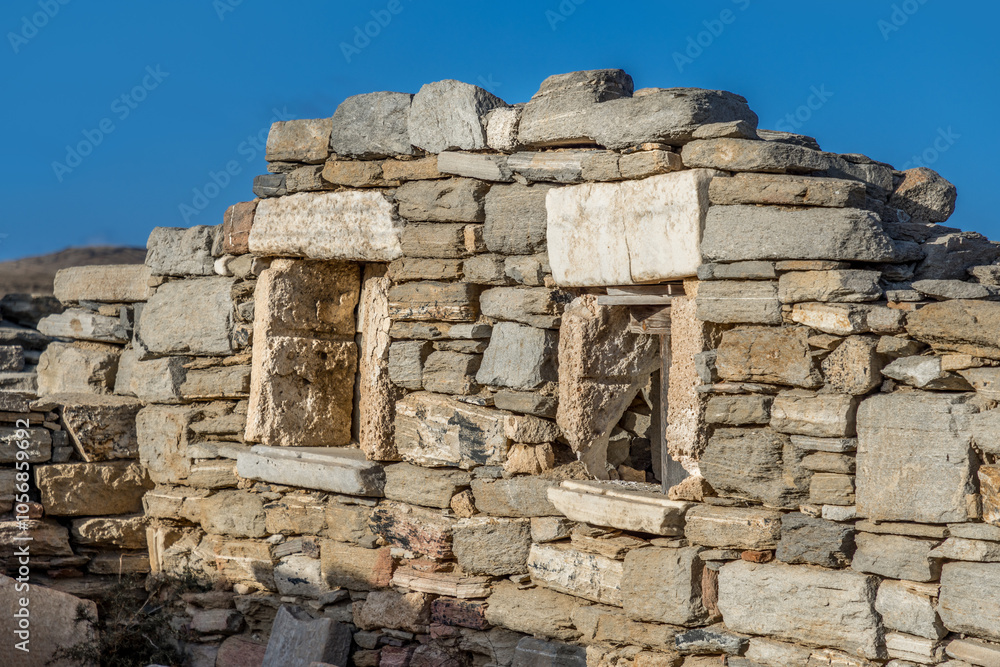Ancient wall of a house on the archeological site. of Delos, Greece, a world heritage site Ancient wall of a house on the archeological site. of Delos, Greece, a world heritage site