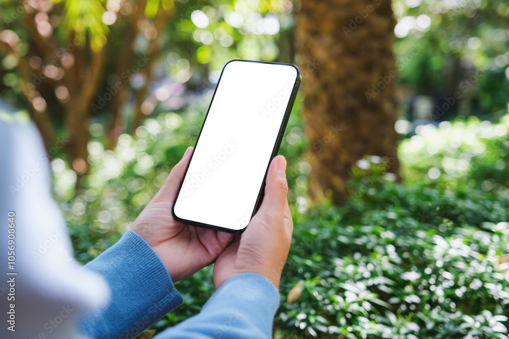 © Farknot Architect - Mockup image of a woman holding mobile phone with blank white desktop screen in the outdoors © Farknot Architect - Mockup image of a woman holding mobile phone with blank white desktop screen in the outdoors