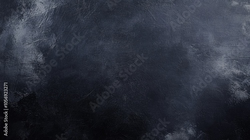 Dark grunge texture with a black background resembling a chalkboard or concrete wallpaper