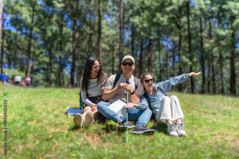 Three Young Friends Hiking in Nature Forest Happy looking for directions Trekking in National Park Three Young Friends Hiking in Nature Forest Happy looking for directions Trekking in National Park