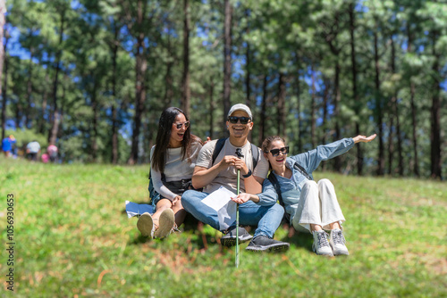 Three Young Friends Hiking in Nature Forest Happy looking for directions Trekking in National Park