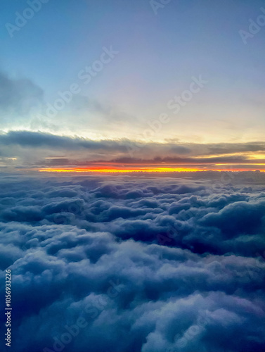 Obraz na płótnie Sunset above the clouds, view from the window of an airplane w salonie