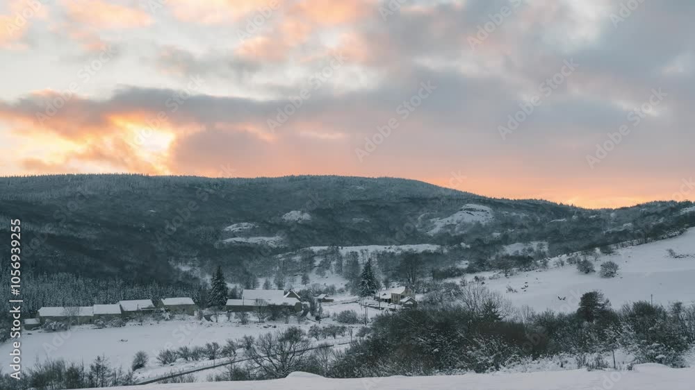 Timelapse of a vibrant sunset over a small snow-covered village in winter. Timelapse of a vibrant sunset over a small snow-covered village in winter.