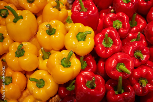 Red and yellow bell peppers in a market, Close-up of colorful bell peppers photo