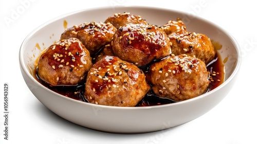 A bowl of meatballs with sesame seeds