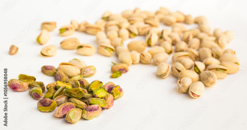 Roasted pistachios on white background Roasted pistachios on white background