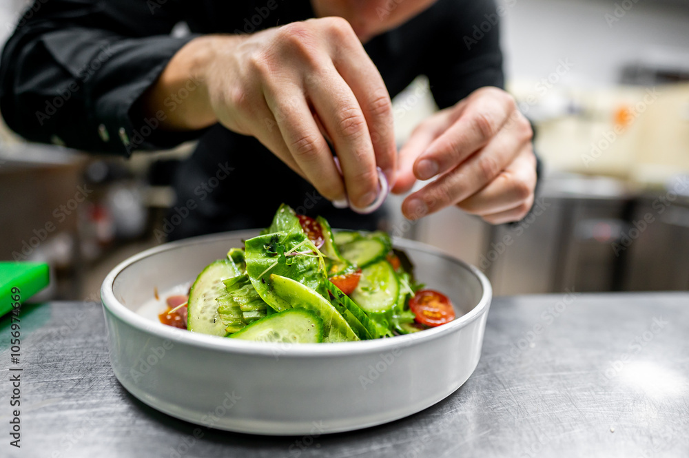 Close-up of a chef’s hands garnishing a fresh salad with herbs in a white bowl, kitchen background. The image captures the essence of culinary art and the freshness of ingredients Close-up of a chef’s hands garnishing a fresh salad with herbs in a white bowl, kitchen background. The image captures the essence of culinary art and the freshness of ingredients