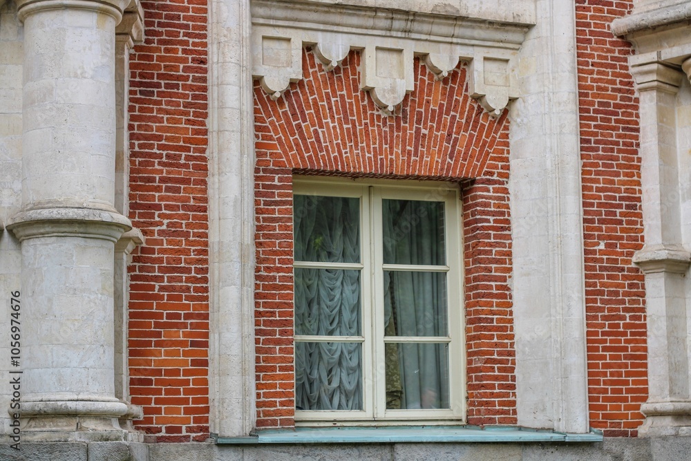 Red brick wall with columns and white window Red brick wall with columns and white window