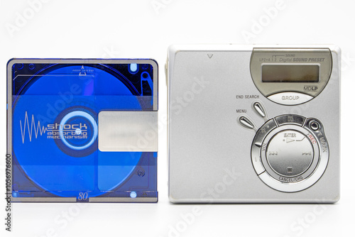 Close-up of a minidisc player and recorder next to a minidisc disc isolated on white background