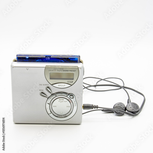 Close-up of a minidisc player and recorder with headphones and a minidisc disc isolated on white background