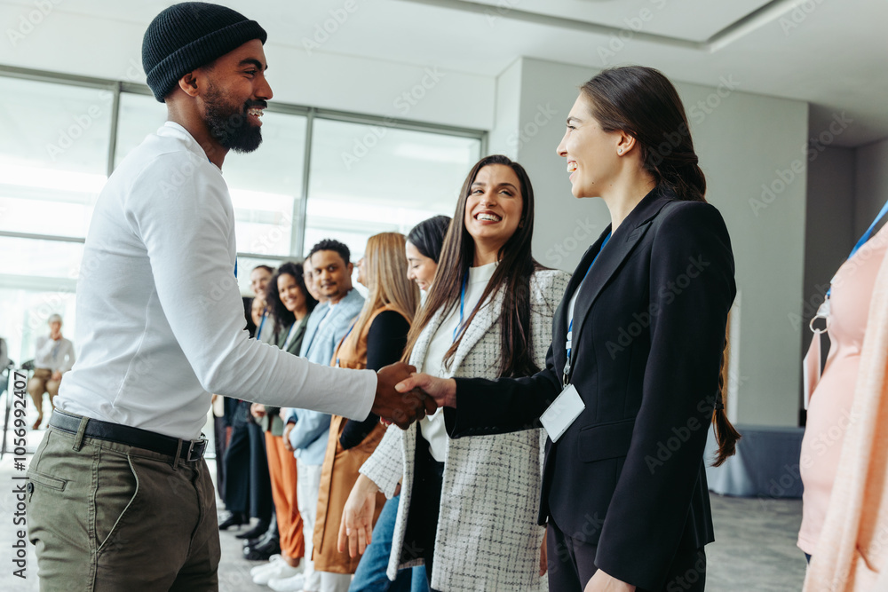 Businesspeople networking and greeting with handshakes at a corporate event Businesspeople networking and greeting with handshakes at a corporate event