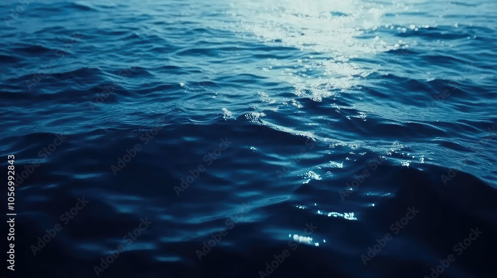 Blue water with ripples and small waves, blurred reflections on surface creating a soft, peaceful ambiance. Blue water with ripples and small waves, blurred reflections on surface creating a soft, peaceful ambiance.