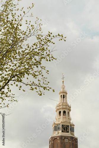 Montelbaanstoren Tower under gray cloudy sky in Amsterdam, Netherlands, vertical shot