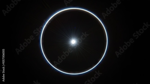 Multi-ringed lens flare with white and blue tones, showing sharp rays against a deep black background.