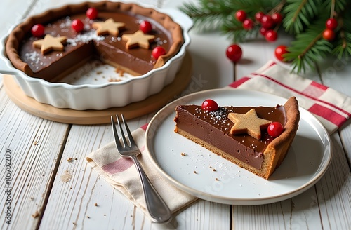  Christmas cutted chololate cake with gingerbreads, rosemary and cranberries on light wooden background photo