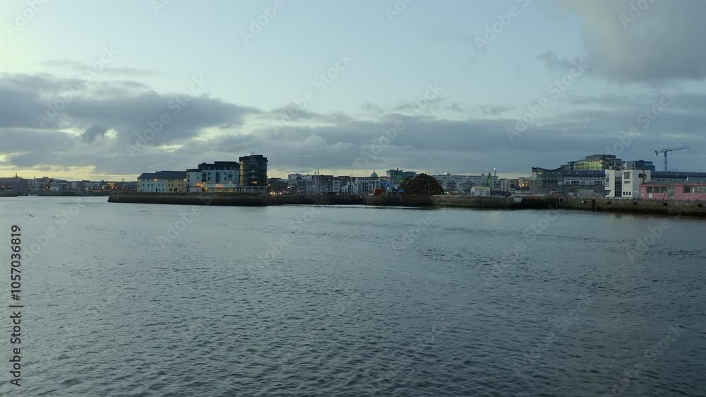 Aerial pan glides over the River Corrib, establishing a view of Galway city Aerial pan glides over the River Corrib, establishing a view of Galway city