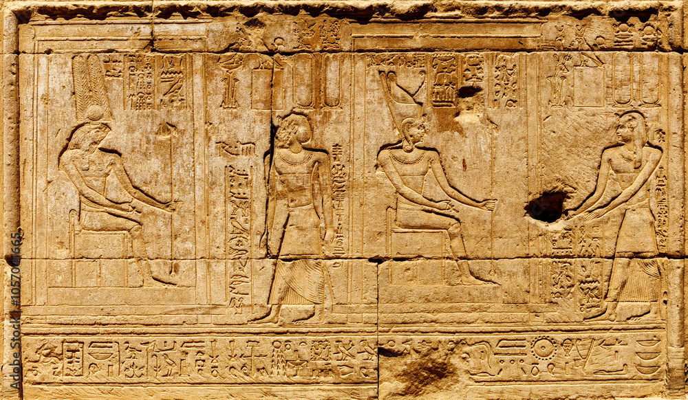 Ancient Egyptian relief features detailed carvings of figures and ...
