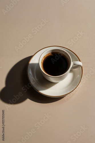 Minimalist white сeramic coffee cup with rich espresso casting shadow on neutral background