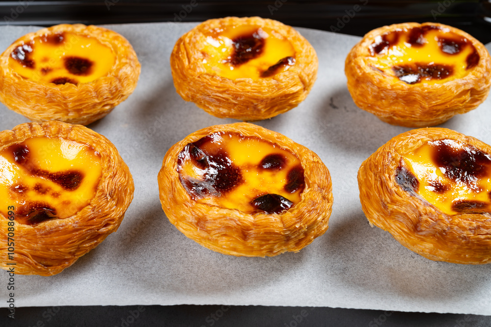 angle view fresh portuguese egg tarts on an oven tray at horizontal composition angle view fresh portuguese egg tarts on an oven tray at horizontal composition