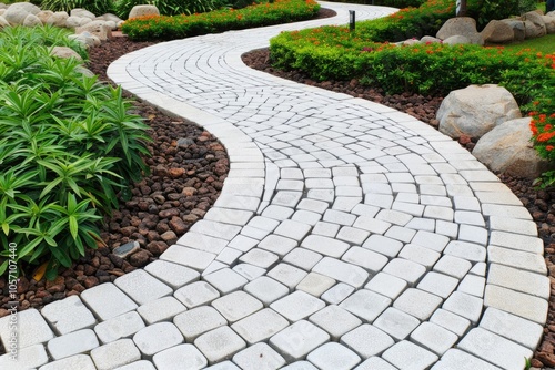 A winding stone pathway meanders through lush greenery, creating an inviting atmosphere in the garden.