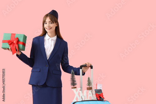 Young stewardess with suitc...