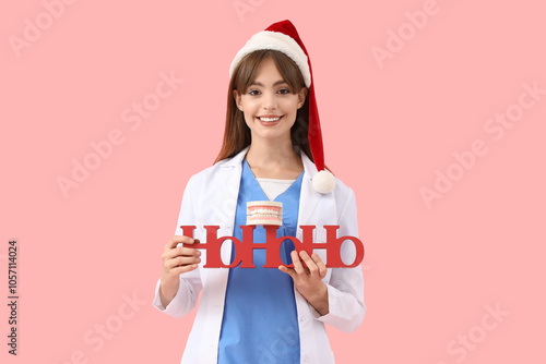 Female dentist in Santa hat...