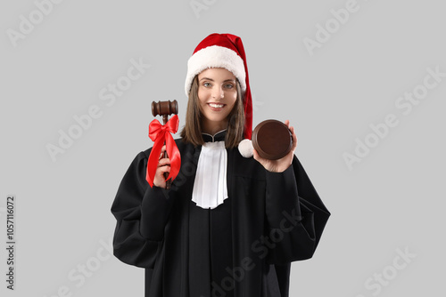 Female judge in Santa hat w...