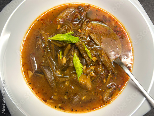 Top view shot of oyster mushroom soup with vegetables and green leaf photo