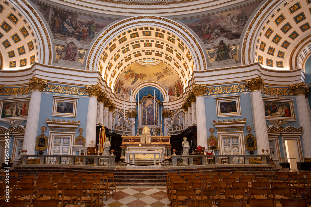 Fototapeta premium Valletta, Malta - May 10, 2024: Interior of the monumental parish church of St Mary dedicated to the Assumption of Our Lady, known as the Mosta Rotunda or Mosta Dome, Cultural heritage of Malta
