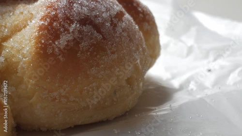 Sweet bread called Bread of the Dead (Pan de Muerto) enjoyed during Day of the Dead festivities in Mexico - closeup slow pan up photo