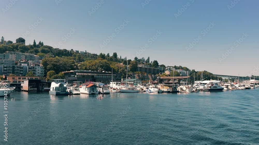 Waterfront Seattle view of docked boats and residential area. A peaceful waterfront scene featuring boats docked near a residential area. Waterfront Seattle view of docked boats and residential area. A peaceful waterfront scene featuring boats docked near a residential area.