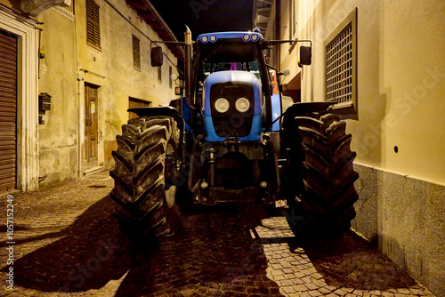 Agricultural tractor for transporting grapes, parked in the street of a rural center of the Langhe, in the province of Cuneo, Italy. photo