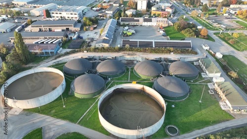 Bio gas station factory plant modern aerial drone view, ecological biomass energy production round roofs biofuel large distribution technological complex, technology distillation pollution, Europe