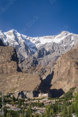 Scenic vertical landscape of Karimabad city with ancient heritage Baltit fort and Ultar Sar mountain background, Hunza, Gilgit-Baltistan, Pakistan photo